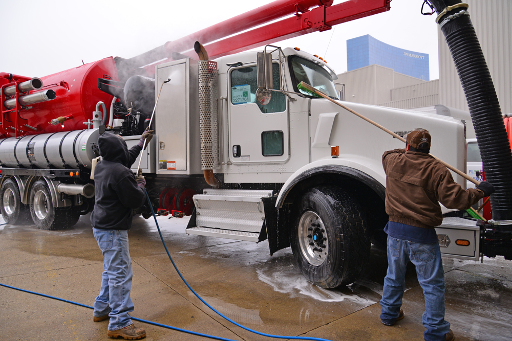 Exhibitors get their rigs show-ready with the truck wash near an outdoor exhibit hall entrance.