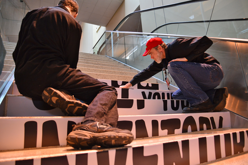 Even the smallest details — like these stair cling graphics — are nailed down before the exhibit hall opens to attendees.