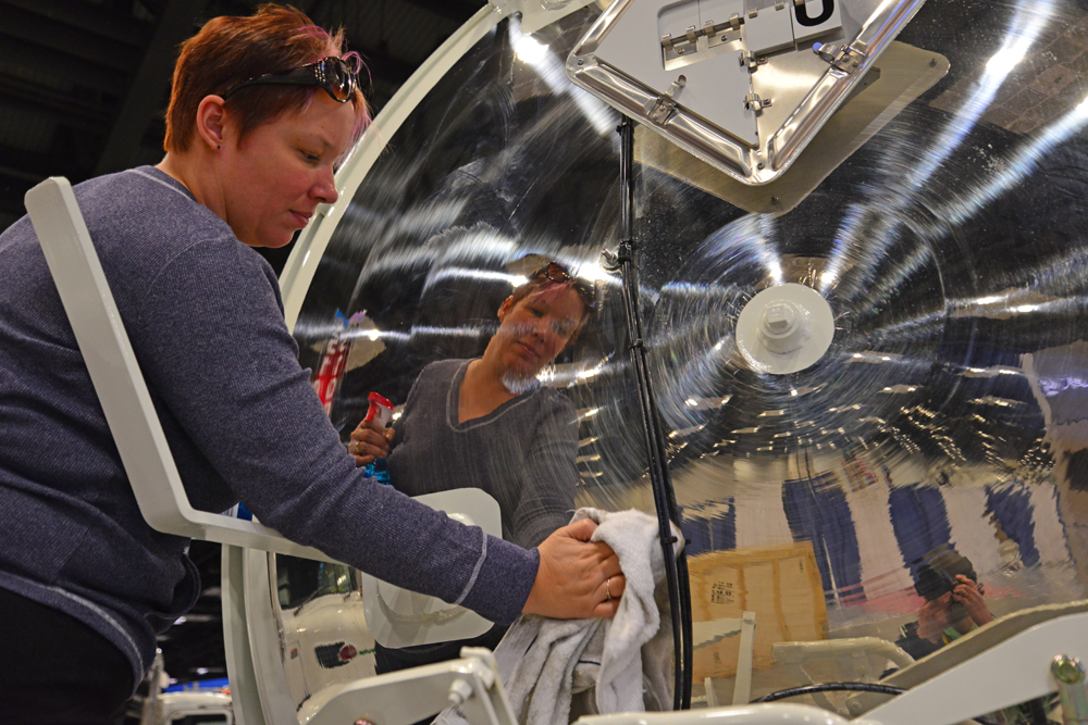 Workers use various cleaners and good 'ol elbow grease to polish trucks and tanks once they're parked in booths.