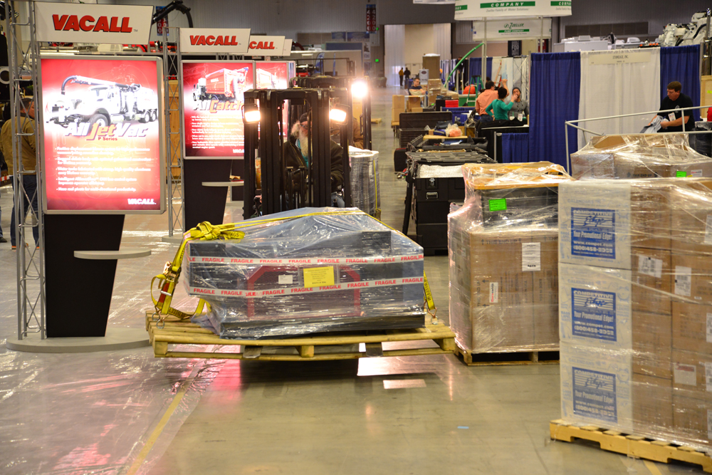 Exhibitors begin move-in a few days before the show opens. Crates and boxes of equipment wait in aisles, ready to be moved to the proper booth.