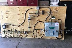 Forrest Anderson Plumbing and AC sets up oxygen gas manifold for donation to PIPE Industries for hands on learning