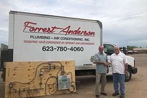 Carl Triphahn Director of P I P E L accepts the medical gas system training donation from Dennis Correll of Forrest Anderson Plumbing and A Cr