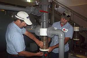 Collections Technicians Performing Maintenance At Vacuum Station